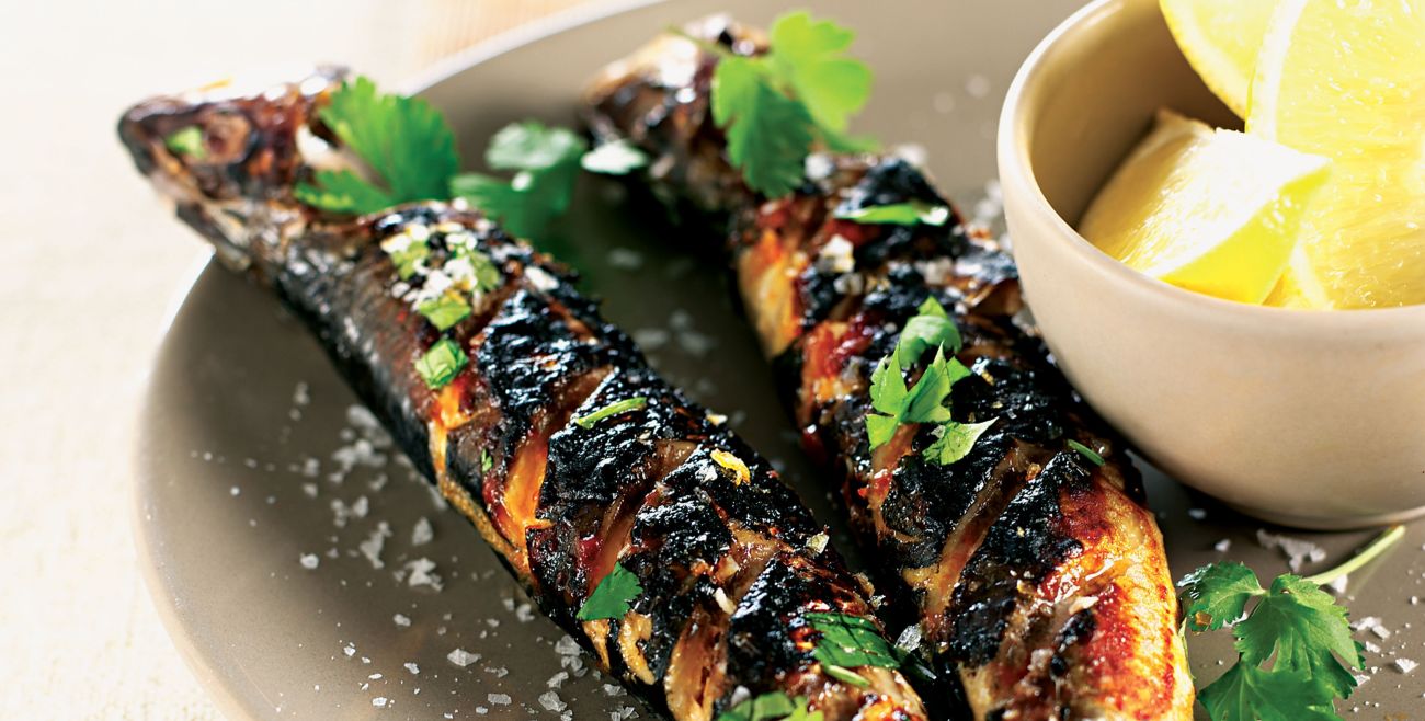 Grilled sardines prepared in traditional Portuguese style at Taberna dos Mercadores, showcasing the authentic and flavorful menu offerings.