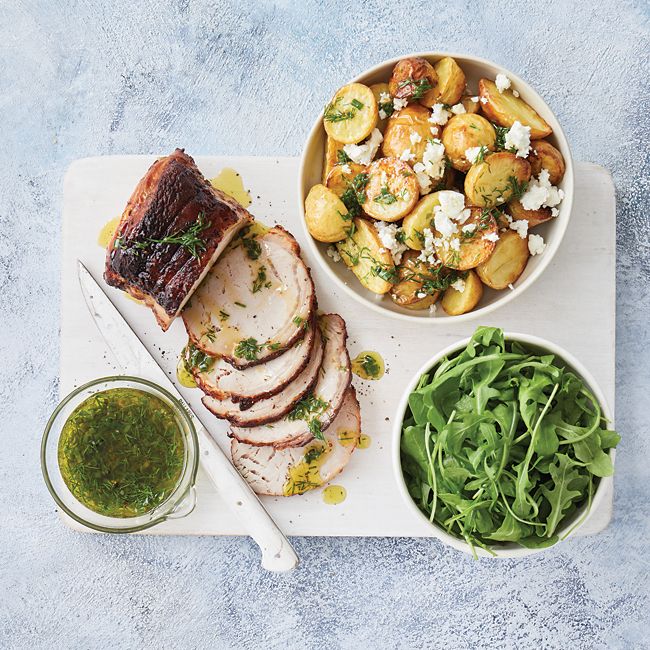 Roast pork with warm herby potatoes & feta salad