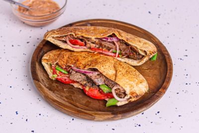 Ribeye Steak Kebab with Iceberg Lettuce, Tomato, Onion & Harissa.