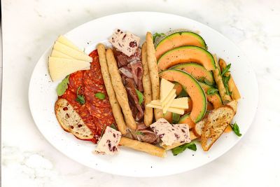 Charcuterie Board Of Artisan Cheese, Chorizo & Parma Ham with Melon.