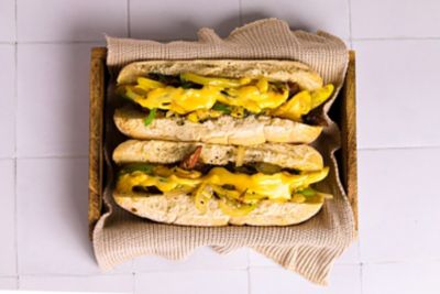 Korean BBQ Philly Cheese Steak with A Cheese Sauce On A Floury Bap.