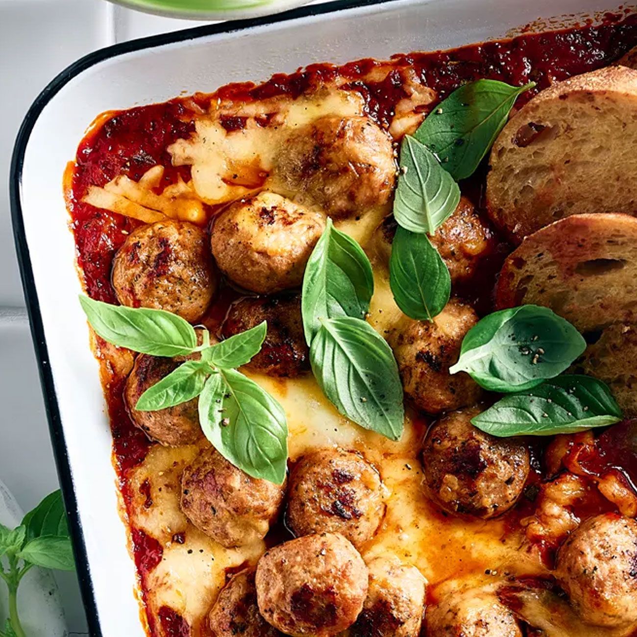 Cheesy meatball bake with crusty garlic bread