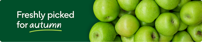 A pile of fresh green apples on a dark green background with the text: Freshly picked for autumn.