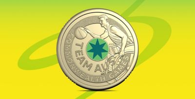 Woolworths Team AUS Commonwealth Games coin featuring a basketball player and star on a green-yellow
