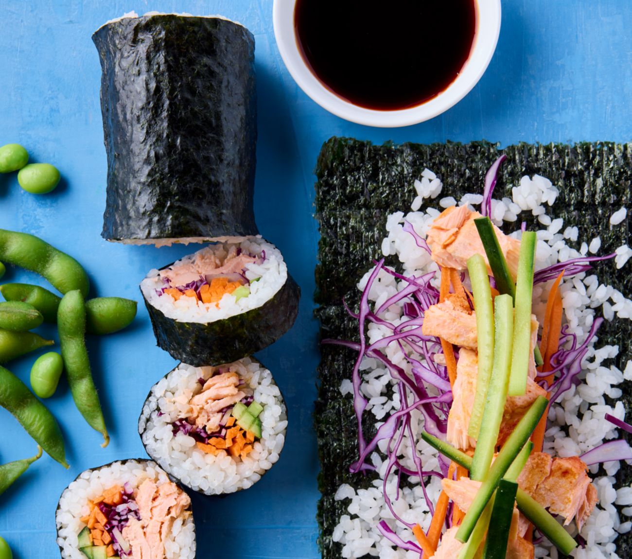 https://foodhub.scene7.com/is/image/woolworthsltdprod/fi-2311-spicy-salmon-sushi-rolls:Mobile-1300x1150