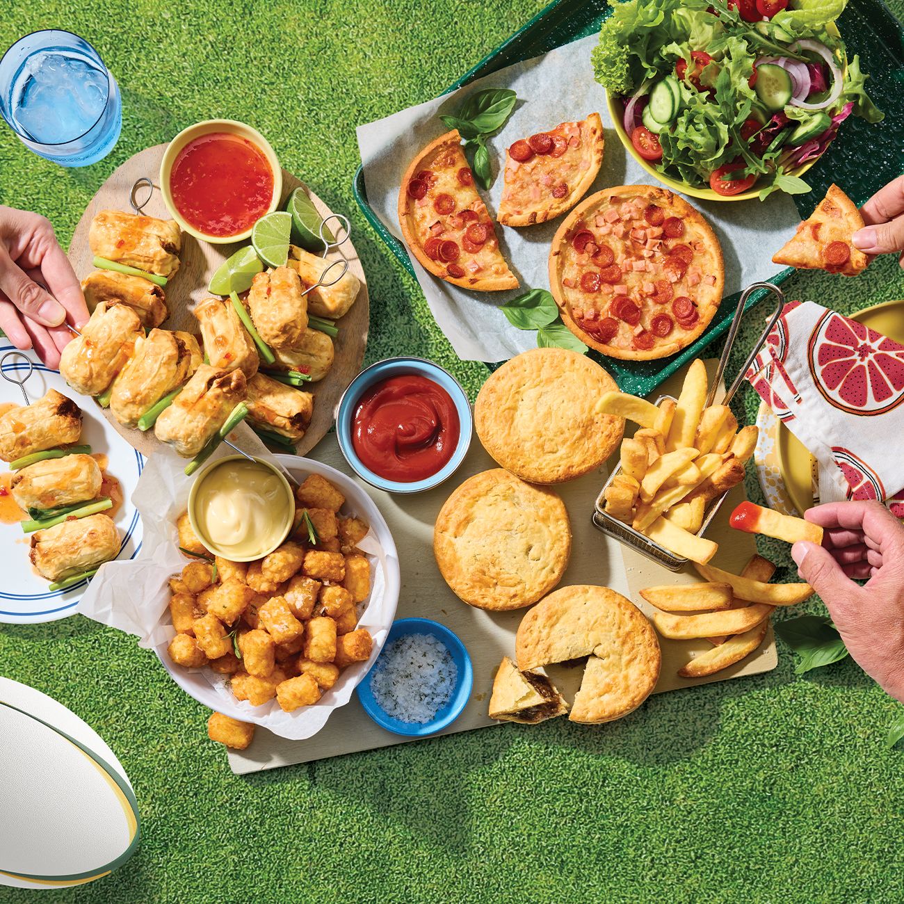 Footy final grazing board with pies, chips, and snacks