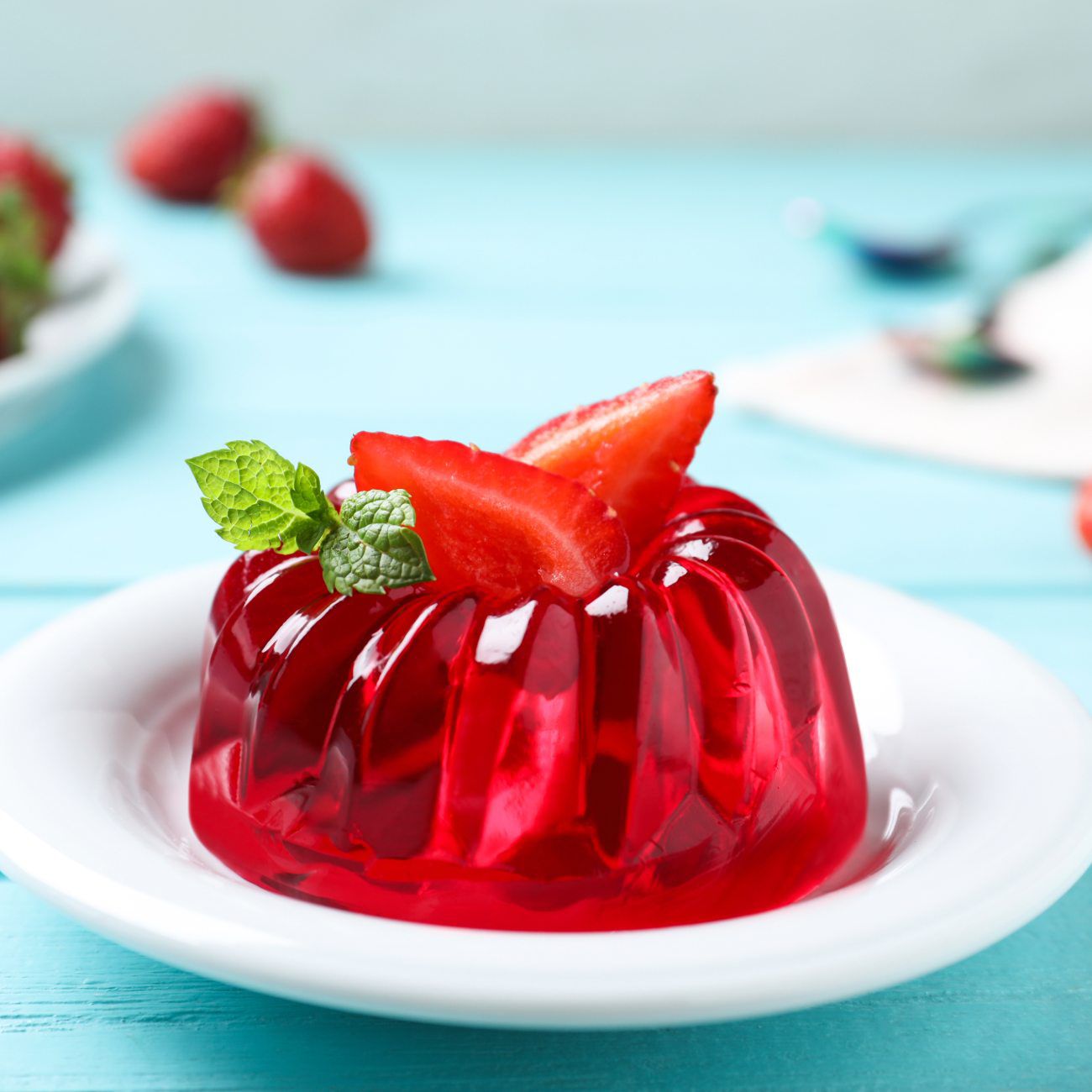 Red jelly dessert with fresh strawberries
