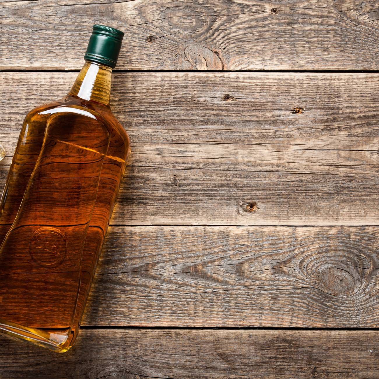 Whiskey bottle and glass on table
